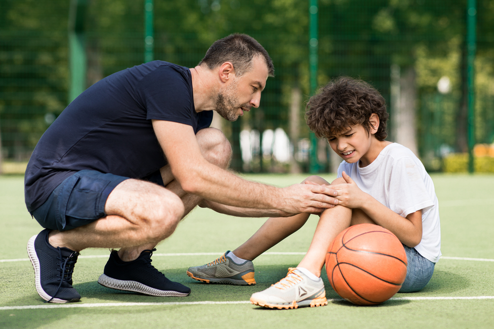 Side,View,Portrait,Of,Focused,Adult,Man,Coach,Helping,Boy